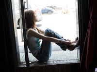 Slender Japanese teen Rika Sakurai exposes her natural pussy in solo action